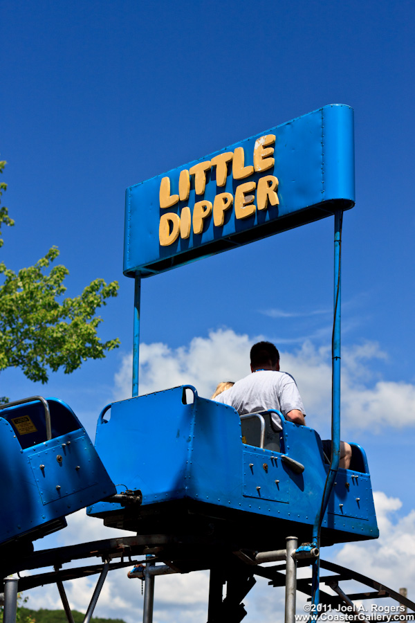 Little Dipper roller coaster passing under the sign