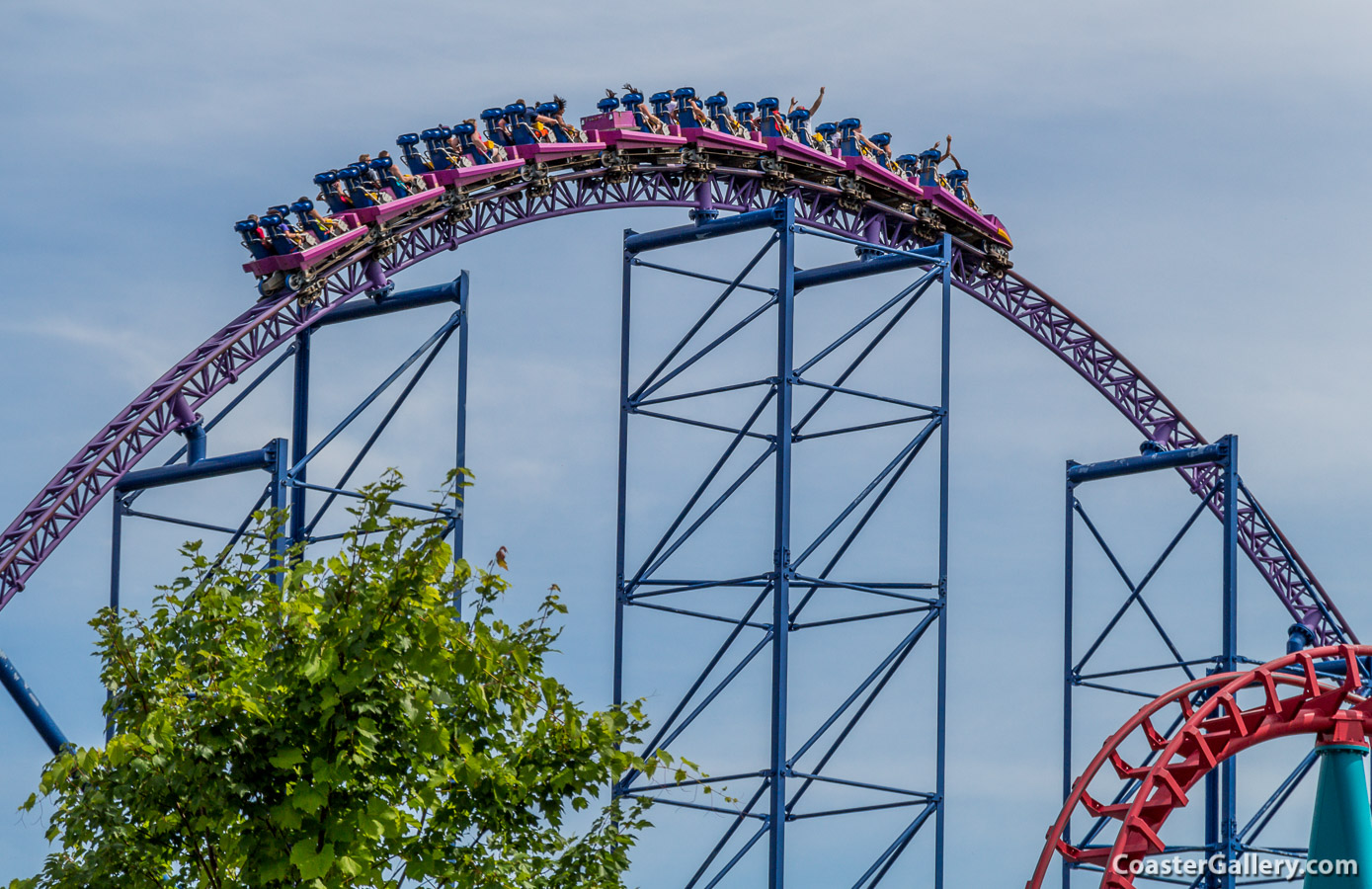 High-speed photography of a roller coaster flying over a hill