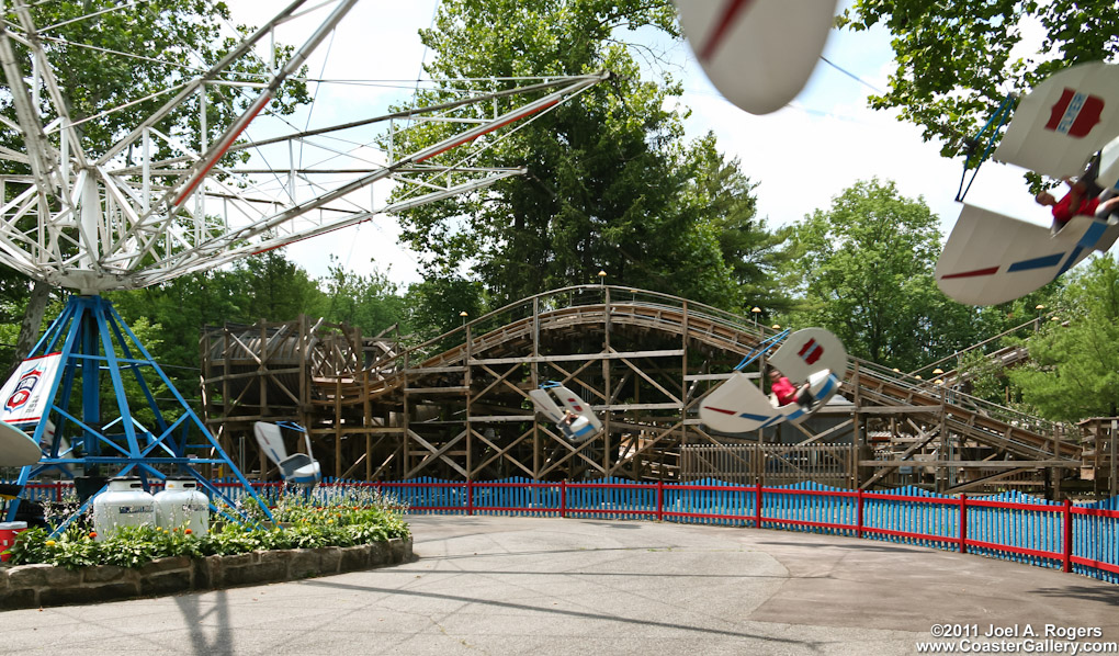 Lift hill on the Flying Turns roller coaster. Foreground is the circle swing ride at Knoebels.