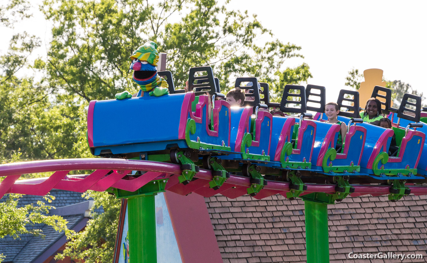 Magnetic breaking system and a statue of the Grover Muppet sitting on Grover's Alpine Express roller coaster
