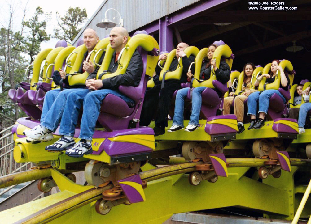 Floorless roller coaster train and riders