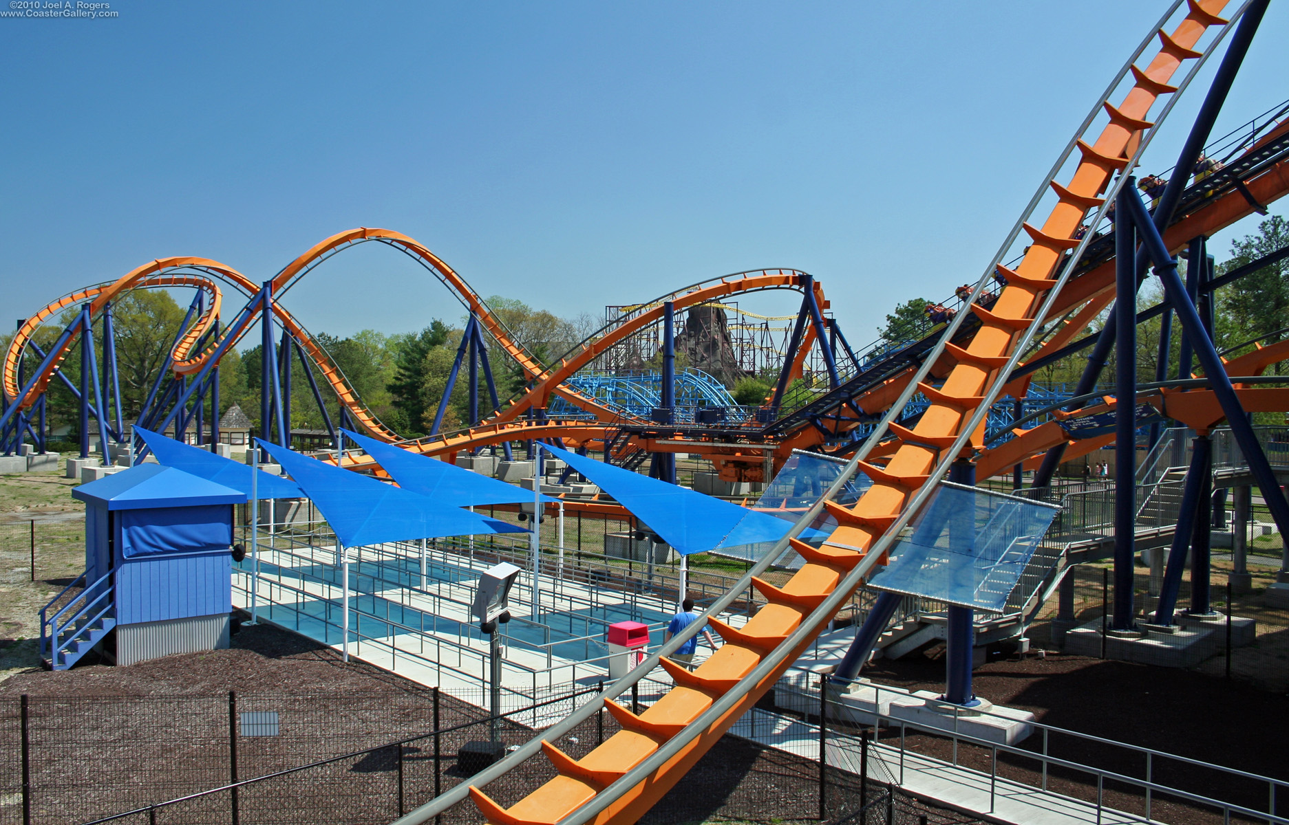 A floorless coaster, a wooden coaster, and an inverted roller coaster