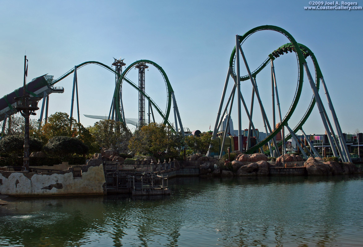 A roller coaster looping over the water