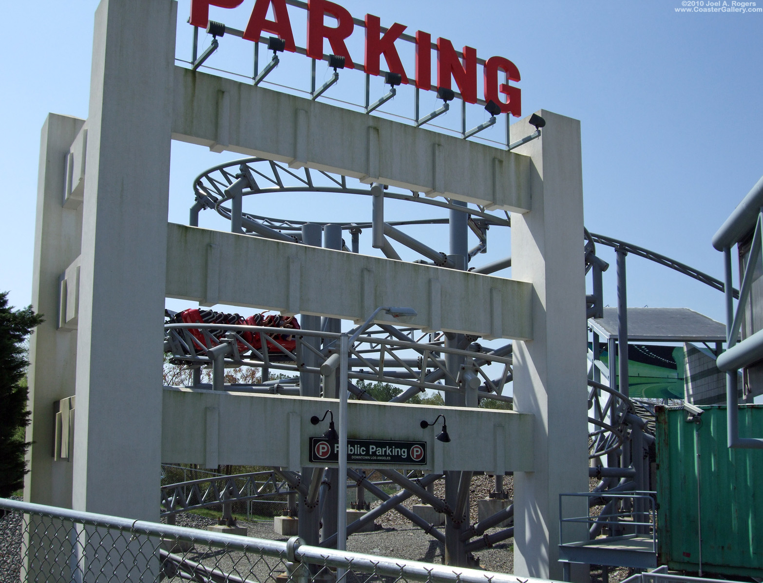 Cars racing through a parking garage - roller coaster built by Premier Rides