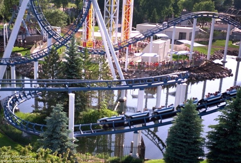 Power Tower and Corkscrew coaster by the water