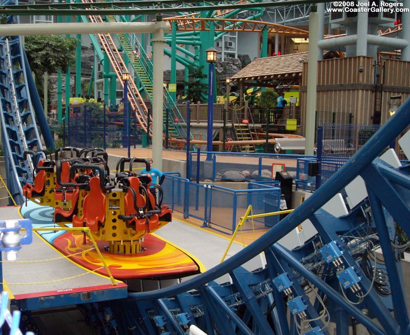 Roller coaster loading platform with spinning chairs