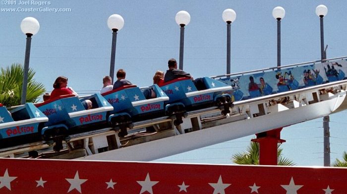 Famous people and cartoons riding the Patriot roller coaster