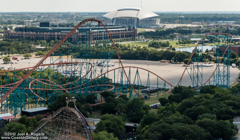Giovanola roller coaster at Six Flags Over Texas. Cowboy stadium and Rangers Ballpark in the background.