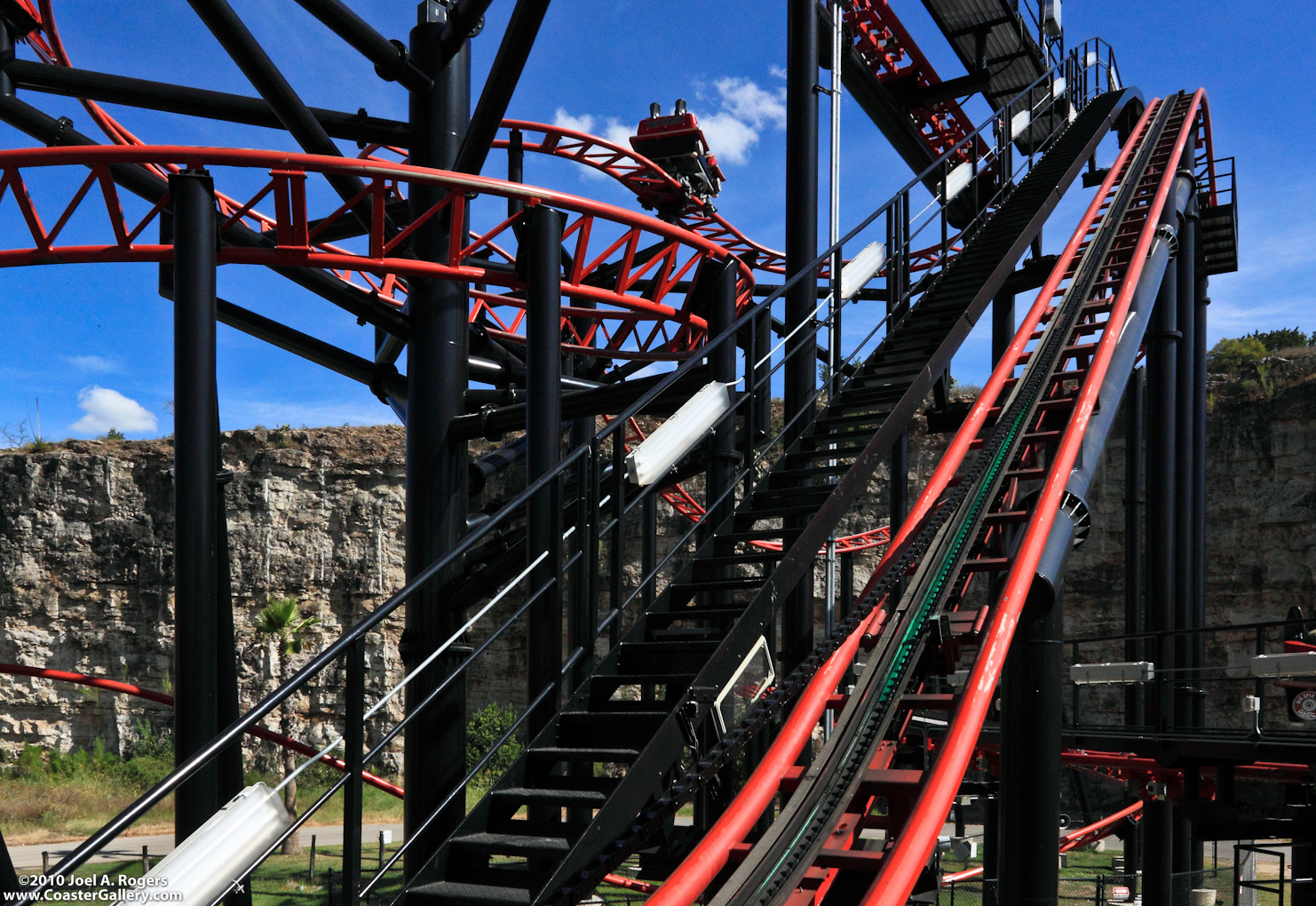 A chain coming out of a roller coaster lift hill. The Pandemonium spinning roller coaster in San Antonio, Texas.