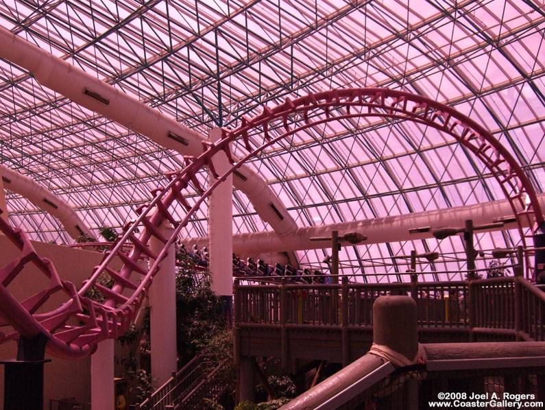Pink-hued glass over a theme park