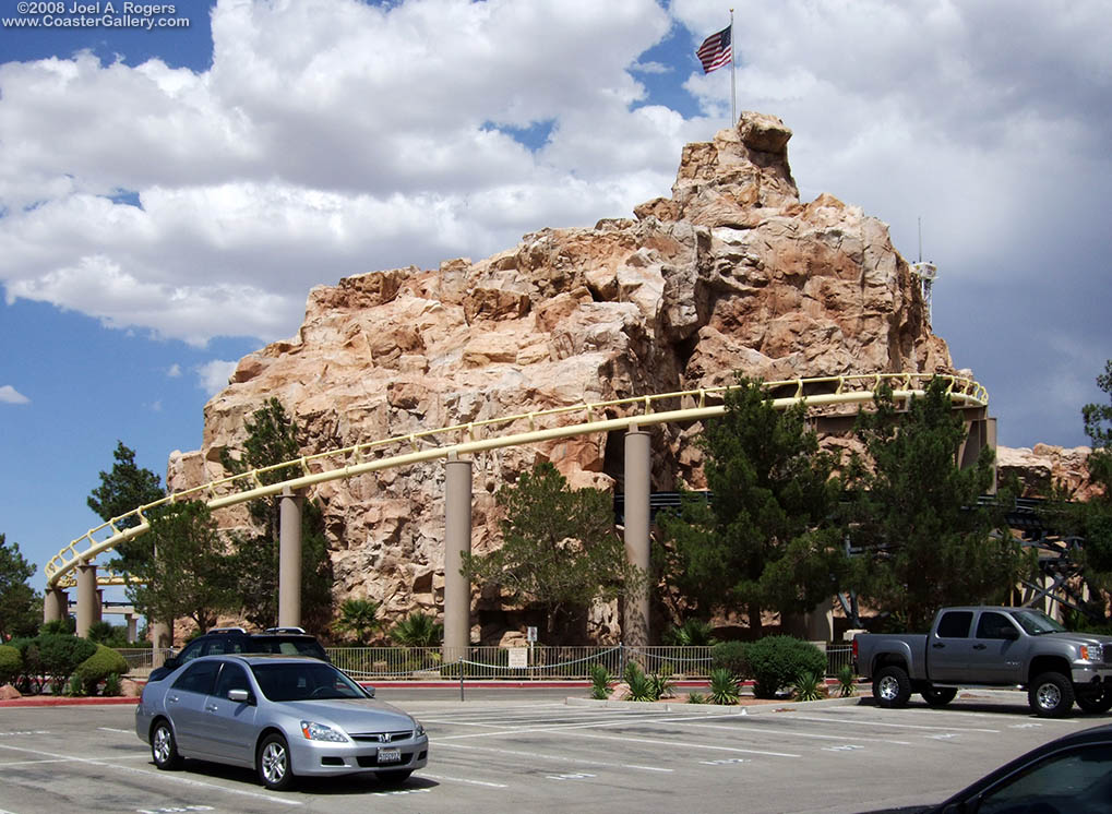 Roller coaster surrounding a fake mountain