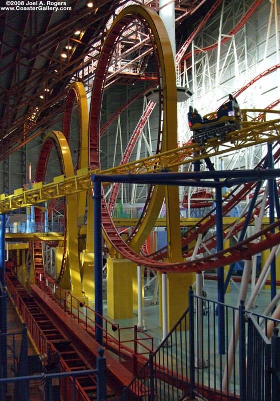 Looping roller coaster next to a spinning roller coaster