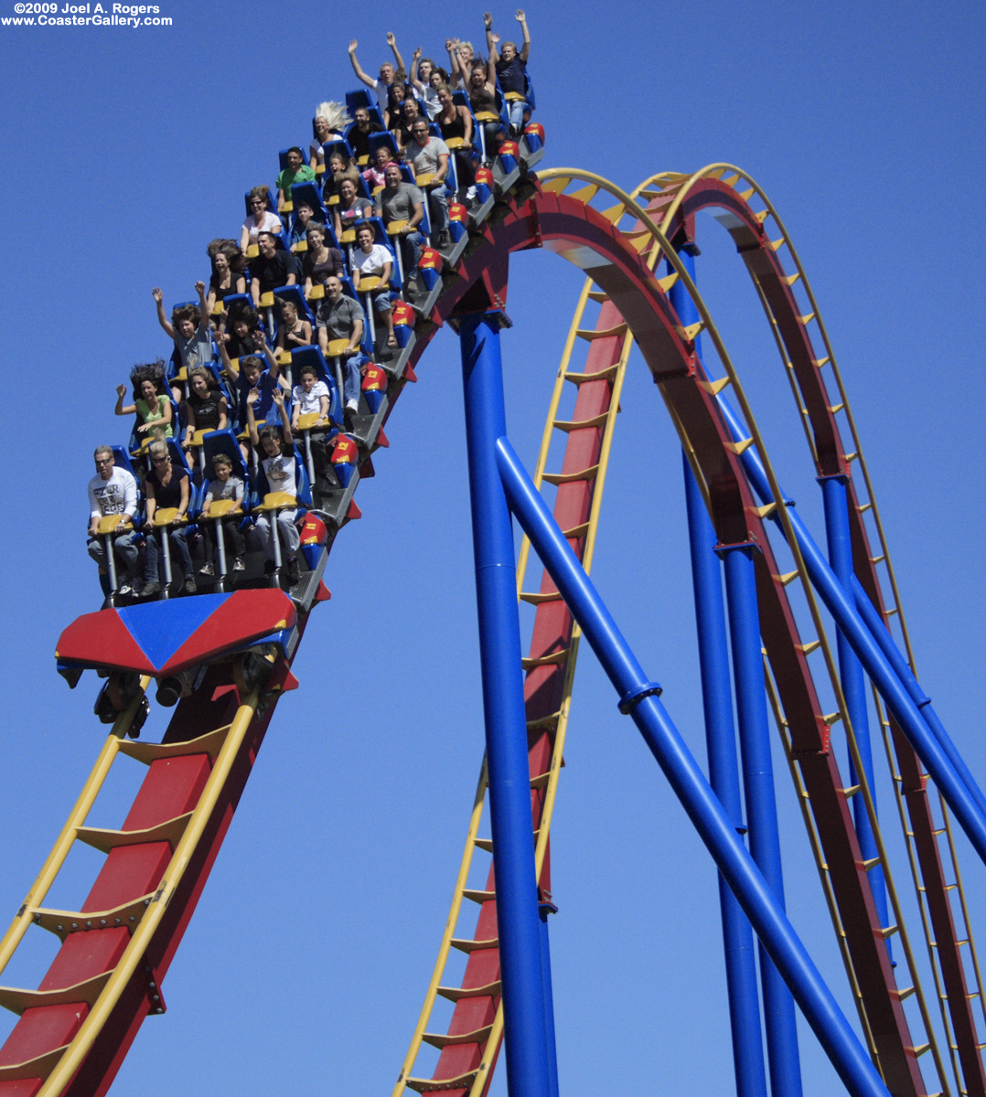 Hands up while cresting the top of a parabolic arch