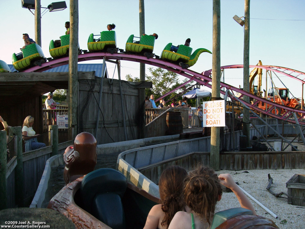 Roller Coaster passing over a log flume ride