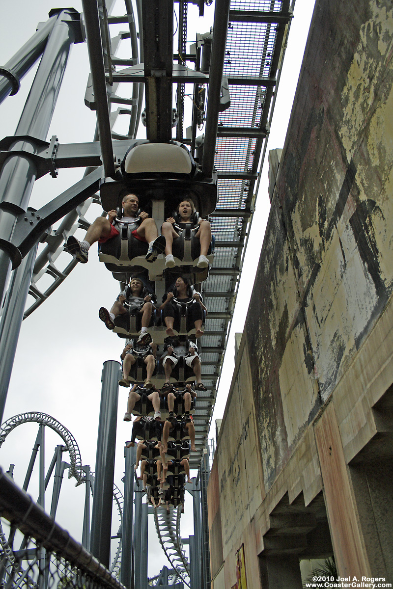Inverted roller coaster hanging under the track