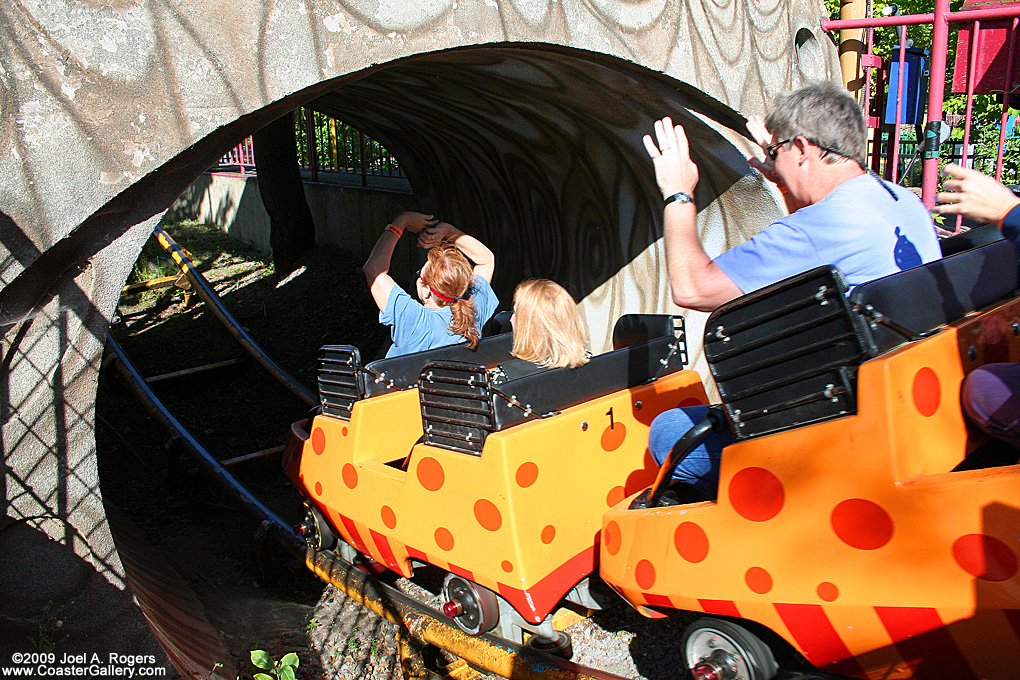 Junior roller coaster entering a tunnel