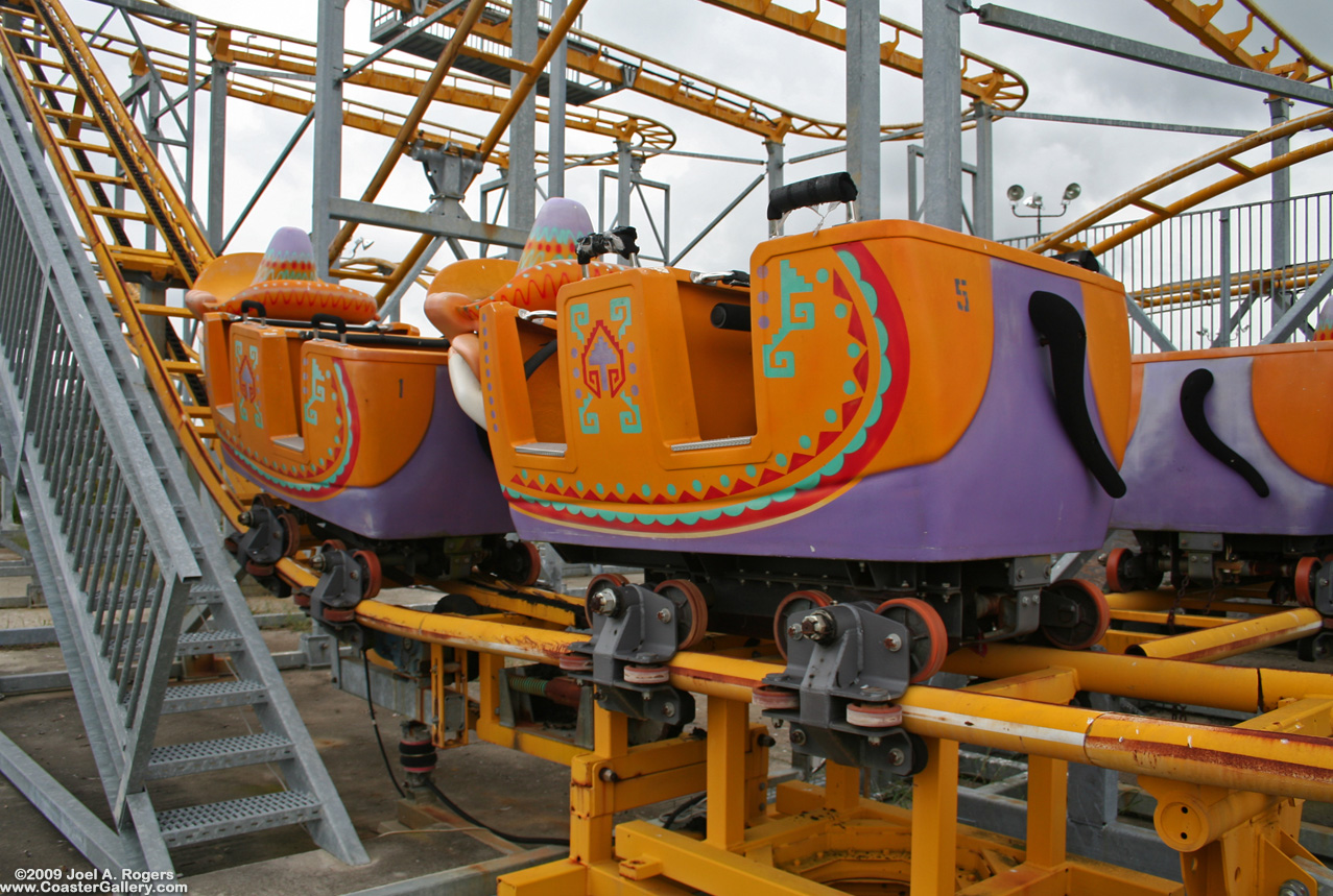 Roller coaster cars sitting on the bottom of a hill