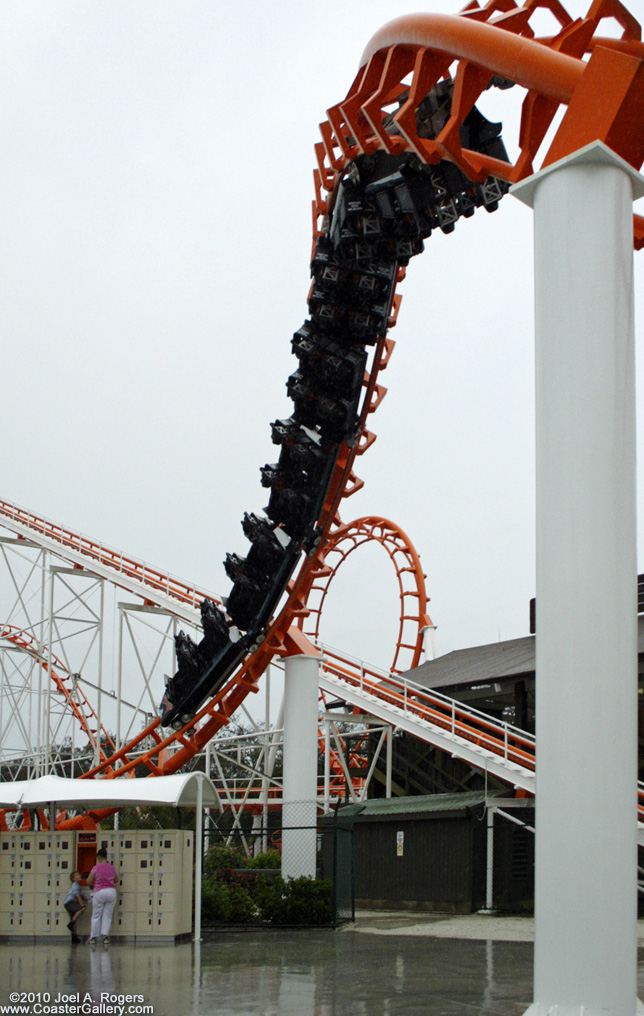 Looping roller coaster passing over people