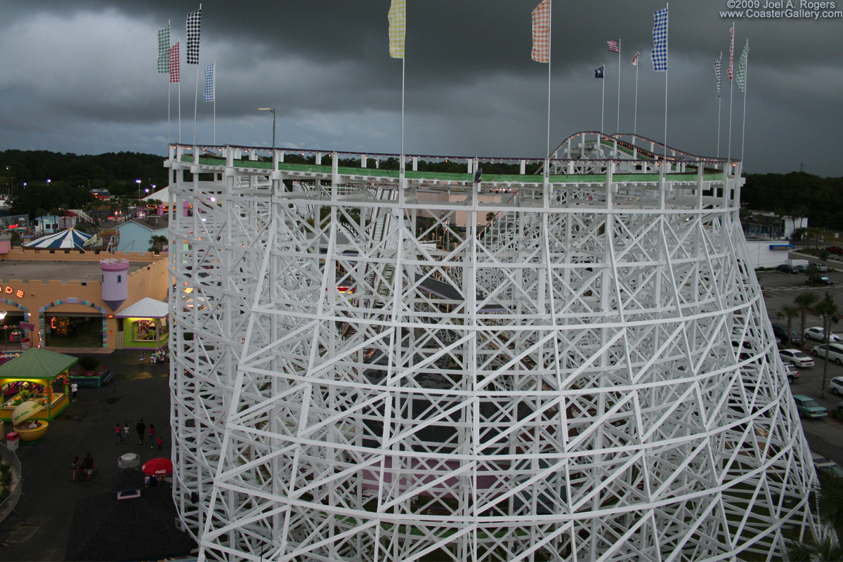 Dark thunderstorm clouds looming over a roller coaster