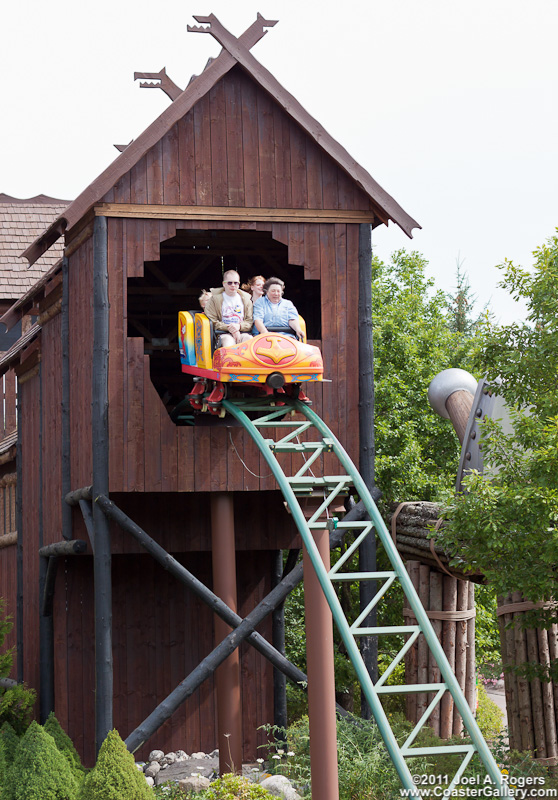 Thor's Hammer roller coaster passing through an old Viking building