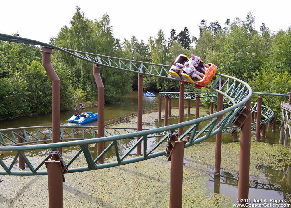 A roller coaster in the woods in Denmark. The ride passes right over a river.