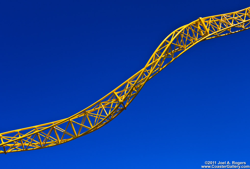 Fine Art photograph of twisted yellow roller coaster track