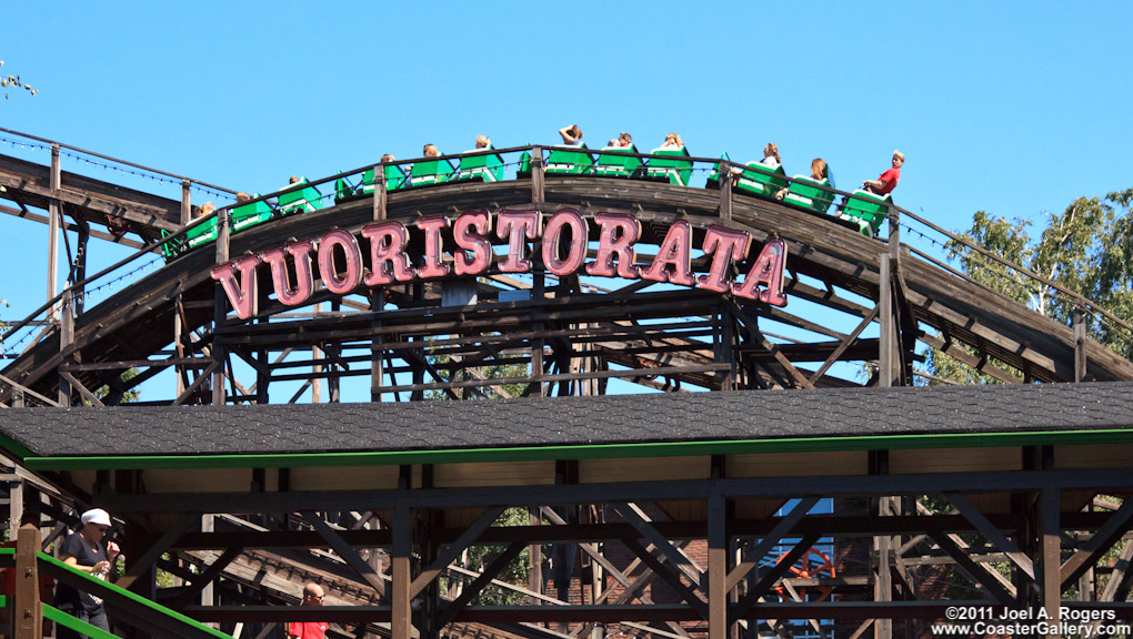 A brakeman standing and operating a roller coaster