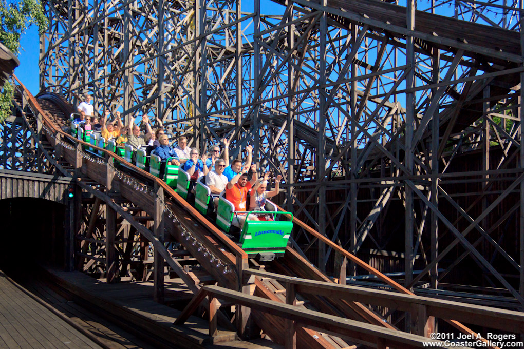 A train full of coaster riders on a double-down hill