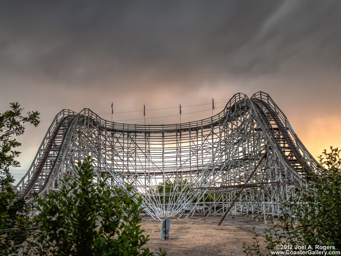 Sunset behind a white roller coaster