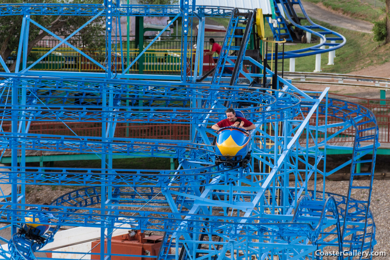 A kid riding baregoot on a roller coaster