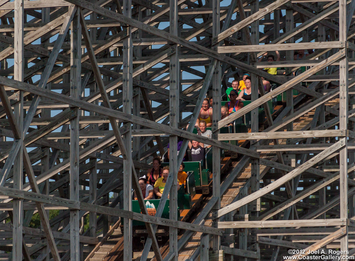 Roller coaster passing through the wooden structure