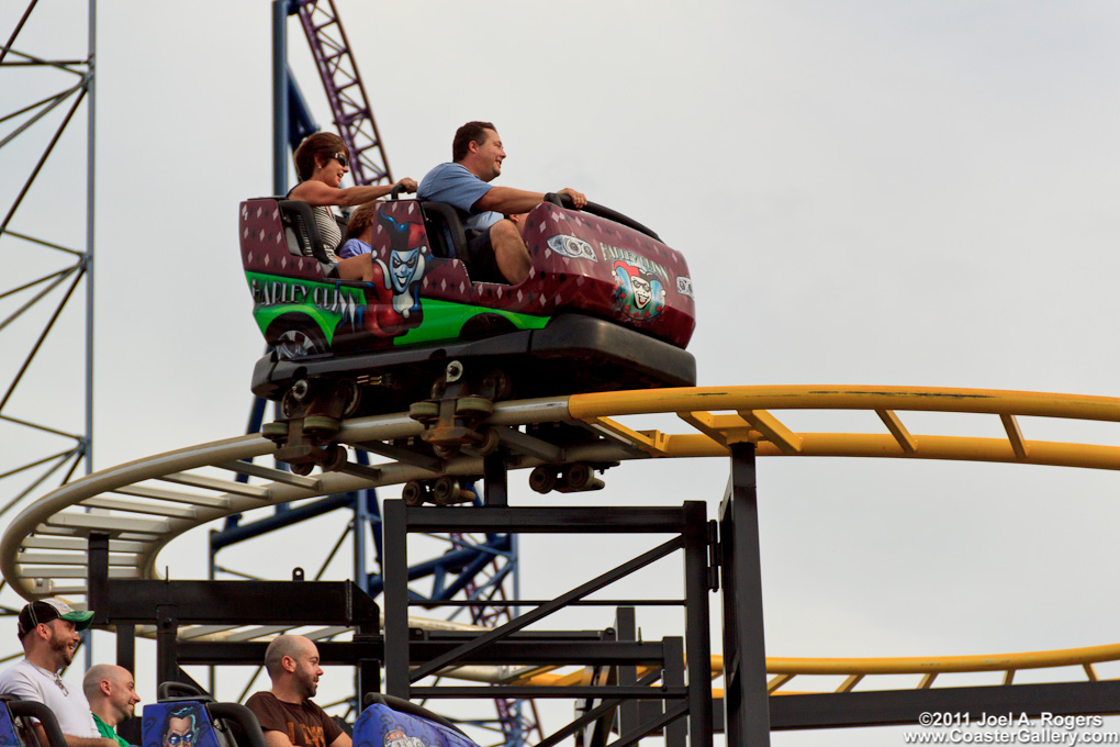 The Riddler and Harley Quinn on roller coaster cars