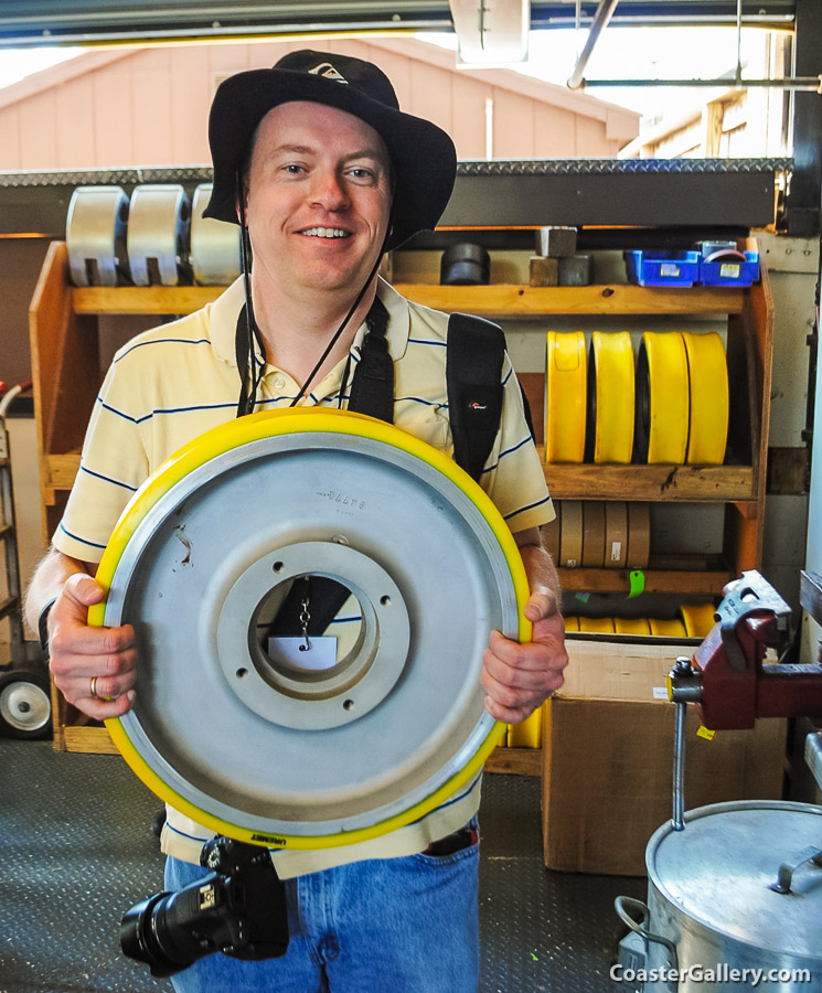 A picture of Joel A. Rogers holding a roller coaster wheel