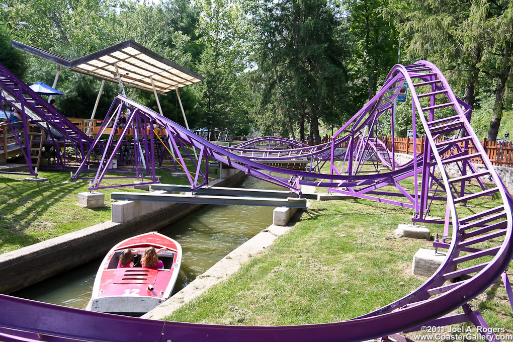 Kozmo's Kurves kiddie coaster passing over a water ride