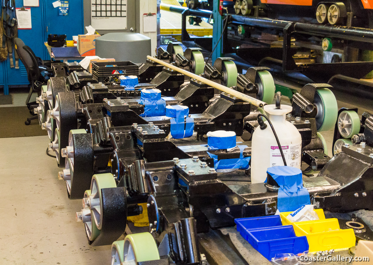 Here are some new wheels, and new suspension assemblies, waiting to be installed on the coaster's cars.