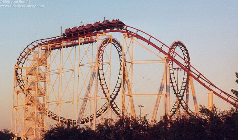 Multi-inversion coaster from Arrow Dynamics at sunset