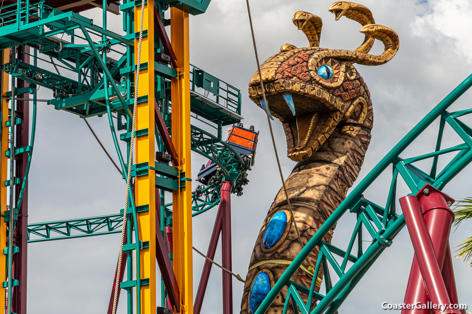 Banking of a roller coaster as it passes a snake statue