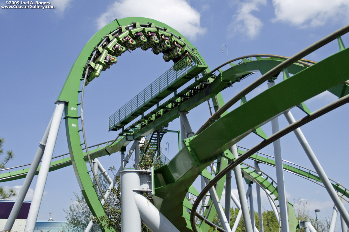 Vertical loop surrounding green roller coaster track.