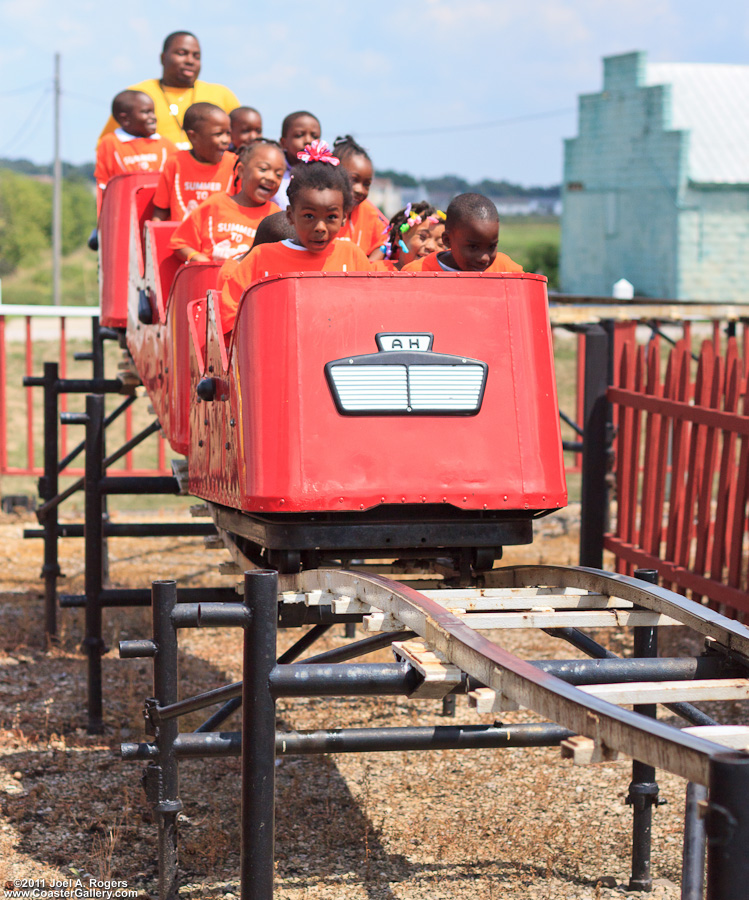 Kids riding a roller coaster