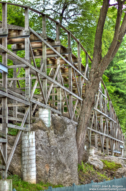 Roller coaster going over rocks and trees