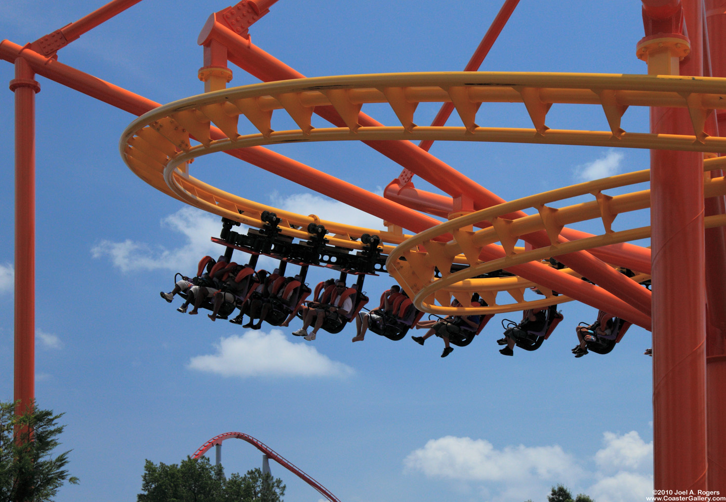 Riders hanging out under a roller coaster