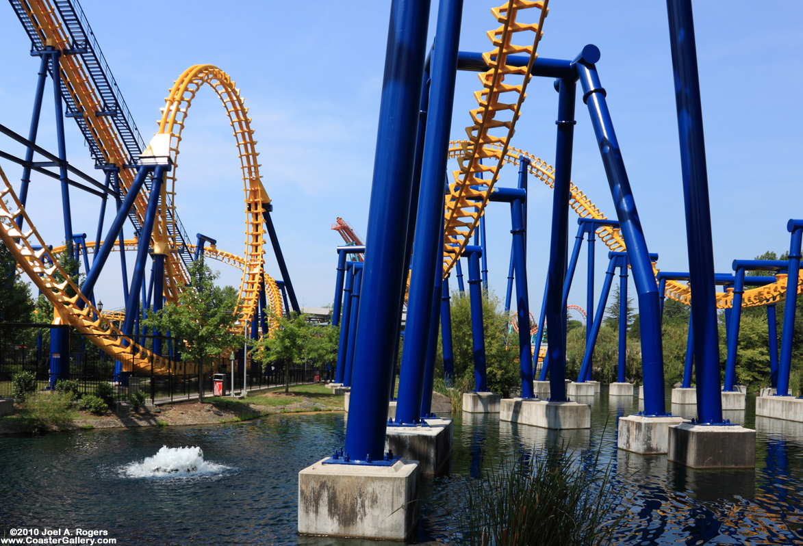 A yellow and blue roller coaster with lots of loops