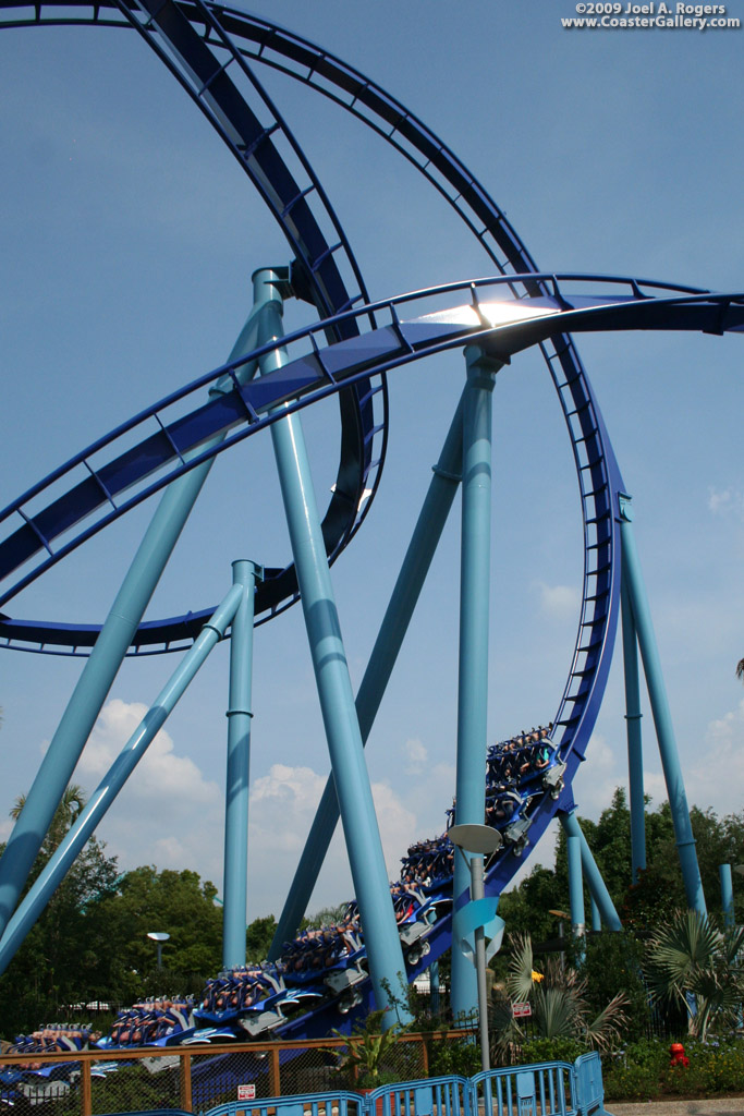 Blue track, blue supports, blue trains, and it goes over blue water.