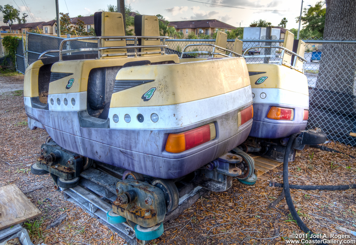 Old roller coaster car rotting and rusting in a field