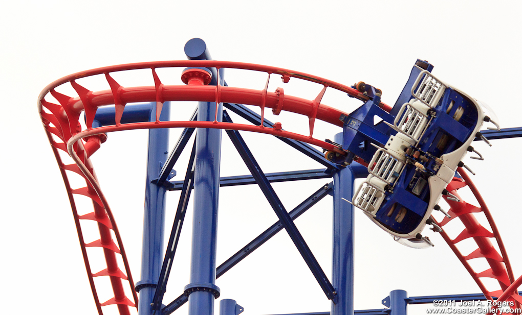 Stock image of a roller coaster flying under the track