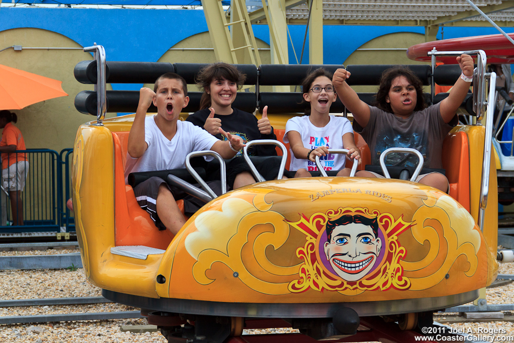 kids in a spinning roller coaster