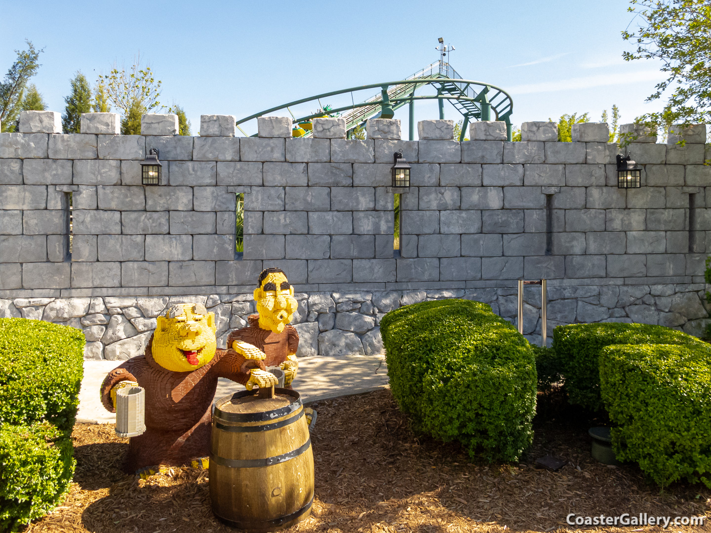 Lego monks drinking outside of The Dragon roller coaster at Legoland Florida