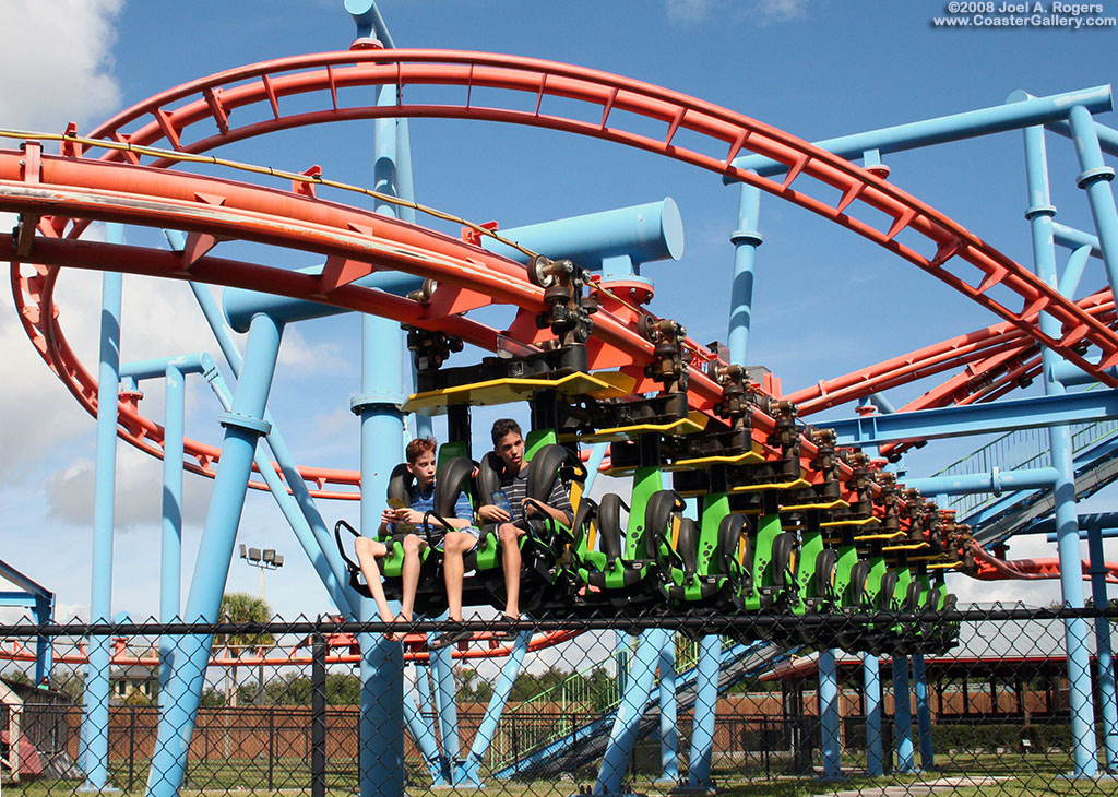 Swamp Thing's train hanging under its tracks. The coaster is now called Flying School