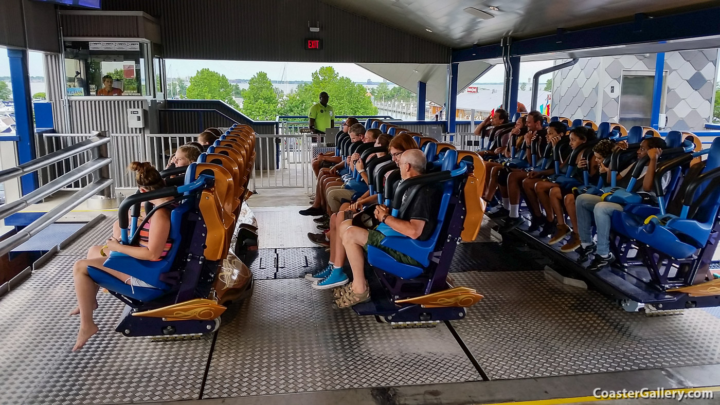 Pictures of a floorless roller coaster in the station. Movable floor and gate are required.