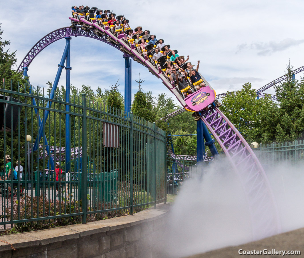 A roller coaster train entering a foggy underground tunnel